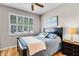 Relaxing bedroom with a wood frame bed, wood floors, and a window with plantation shutters at 3714 Marigot Way, Clermont, FL 34711
