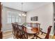 Elegant dining room features a dark wood table, decorative accents, and natural light from the large window at 3714 Marigot Way, Clermont, FL 34711