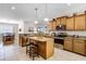 Well-equipped kitchen with a central island, stainless steel appliances, granite countertops, and breakfast bar seating at 3714 Marigot Way, Clermont, FL 34711