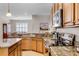 Gourmet kitchen featuring granite countertops, ample cabinet space, stainless steel appliances, and modern fixtures at 3714 Marigot Way, Clermont, FL 34711
