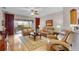 Bright living room boasts tan leather furniture, a ceiling fan, and sliding glass doors to the patio at 3714 Marigot Way, Clermont, FL 34711