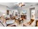 Spacious living room with tan leather furniture, TV, and open access to the kitchen and dining areas at 3714 Marigot Way, Clermont, FL 34711