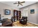 Comfortable home office includes a leather chair, bookshelf, desk, and natural light from the window at 3714 Marigot Way, Clermont, FL 34711
