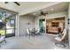 Spacious outdoor patio with a ceiling fan, sliding doors, and various seating arrangements at 3714 Marigot Way, Clermont, FL 34711