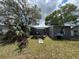 View of the backyard showing a small patio area with outdoor seating and a grill at 3845 Sw 148Th Pl, Ocala, FL 34473