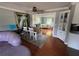 Open-concept dining room featuring hardwood floors, crown molding, and view into the living room at 3845 Sw 148Th Pl, Ocala, FL 34473