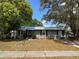 Charming single-story home featuring a metal roof, gray exterior paint, and a well-maintained front yard at 3845 Sw 148Th Pl, Ocala, FL 34473