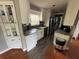 Stylish kitchen with white cabinetry, granite countertops, stainless steel appliances, and a modern light fixture at 3845 Sw 148Th Pl, Ocala, FL 34473