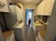 Efficient laundry area features stacked washer and dryer, ample cabinet space and adjacent wash basin at 3845 Sw 148Th Pl, Ocala, FL 34473