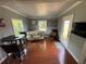 Cozy living room featuring hardwood floors, natural light from the windows, and comfortable seating at 3845 Sw 148Th Pl, Ocala, FL 34473