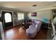 Inviting living room with hardwood floors, crown molding, and a comfortable seating arrangement at 3845 Sw 148Th Pl, Ocala, FL 34473
