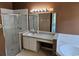 Bathroom features a glass enclosed shower, large mirror, and a combination tub and shower at 4526 Oakton Dr, Orlando, FL 32818