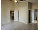 Bedroom with tile floors, a ceiling fan, and doorways to the kitchen and main bathroom at 4526 Oakton Dr, Orlando, FL 32818