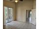 A bedroom with tile floors and access to both the screened patio and the hallway leading to the bathroom at 4526 Oakton Dr, Orlando, FL 32818