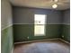 Bedroom showcasing a window, ceiling fan, and two-tone paint scheme at 4526 Oakton Dr, Orlando, FL 32818