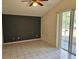 A bedroom with tiled flooring, a ceiling fan, and sliding door access to the screened patio at 4526 Oakton Dr, Orlando, FL 32818