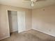 Bedroom showcasing a closet, ceiling fan, and walls in need of repair at 4526 Oakton Dr, Orlando, FL 32818