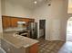 Well-lit kitchen with ample counter space, stainless steel appliances, and direct access to the laundry room at 4526 Oakton Dr, Orlando, FL 32818
