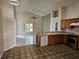 Bright kitchen featuring tile floors, wooden cabinets, modern appliances, and a view into the adjacent living area at 4526 Oakton Dr, Orlando, FL 32818