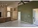 Open living space with tile floors, sliding door access to the patio, and views of the kitchen and dining area at 4526 Oakton Dr, Orlando, FL 32818