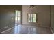 Bright living room with tile flooring, a large window, and sliding glass doors that lead to the outdoor patio at 4526 Oakton Dr, Orlando, FL 32818