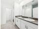 Well-lit bathroom boasts a double sink vanity with modern fixtures and a separate toilet area at 4701 Jasmine Cir, Leesburg, FL 34748