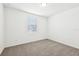 Neutral bedroom with carpet flooring, a window with blinds, and white walls at 4701 Jasmine Cir, Leesburg, FL 34748