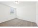 Neutral bedroom with carpet flooring, a window with blinds, and white walls at 4701 Jasmine Cir, Leesburg, FL 34748