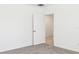 Neutral bedroom with carpet flooring, white walls, and a doorway at 4701 Jasmine Cir, Leesburg, FL 34748