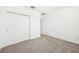 Neutral bedroom with carpet flooring, a closet with doors, and white walls at 4701 Jasmine Cir, Leesburg, FL 34748