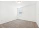 The bedroom offers neutral walls, carpet, and a window for natural light at 4701 Jasmine Cir, Leesburg, FL 34748