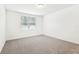 The bedroom offers neutral walls, carpet, and a window for natural light at 4701 Jasmine Cir, Leesburg, FL 34748