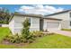 Well-maintained one-story home showcasing a two-car garage, landscaped yard, and neat lawn at 4701 Jasmine Cir, Leesburg, FL 34748