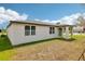 Rear view of the house with a patio, and large windows at 4701 Jasmine Cir, Leesburg, FL 34748