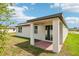 Rear view of the house showcasing the covered brick patio and backyard at 4701 Jasmine Cir, Leesburg, FL 34748