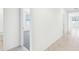 Bright hallway with tile flooring, neutral paint and doors leading to carpeted bedrooms at 4701 Jasmine Cir, Leesburg, FL 34748