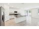 Modern kitchen featuring white cabinets, stainless steel appliances, and a center island at 4701 Jasmine Cir, Leesburg, FL 34748