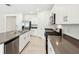 Bright kitchen features stainless appliances, large island with sink, and white cabinetry at 4701 Jasmine Cir, Leesburg, FL 34748
