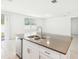 Bright kitchen with stainless steel appliances, a large island, and tile flooring at 4701 Jasmine Cir, Leesburg, FL 34748