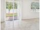 Bright living room featuring tile flooring, sliding glass doors to backyard, and neutral walls at 4701 Jasmine Cir, Leesburg, FL 34748