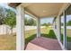 Brick patio area with a view of the fenced backyard and surrounding greenery at 4701 Jasmine Cir, Leesburg, FL 34748