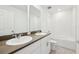 Bathroom featuring a double vanity with quartz countertops and a combined tub and shower at 4705 Jasmine Cir, Leesburg, FL 34748