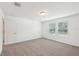 This bedroom boasts two large windows and neutral carpeting at 4705 Jasmine Cir, Leesburg, FL 34748