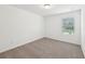 Bright bedroom featuring carpet floors, and a window with exterior views at 4705 Jasmine Cir, Leesburg, FL 34748