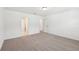 Large bedroom has neutral carpeting and access to an ensuite bathroom and closet at 4705 Jasmine Cir, Leesburg, FL 34748