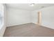 Bright bedroom featuring neutral carpeting and an open doorway at 4705 Jasmine Cir, Leesburg, FL 34748