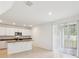 A modern kitchen features white cabinets and a sliding glass door at 4705 Jasmine Cir, Leesburg, FL 34748