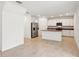 Bright kitchen with stainless steel appliances, a kitchen island, and white cabinets at 4705 Jasmine Cir, Leesburg, FL 34748