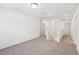 A spacious loft area features carpet flooring and multiple doors and hallway entries at 4705 Jasmine Cir, Leesburg, FL 34748