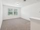 Upstairs loft space with carpet flooring, dual windows with blinds, and overhead lighting at 4705 Jasmine Cir, Leesburg, FL 34748